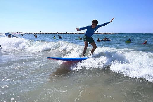 A Torah Tech student surfing a wave off the Israeli coast